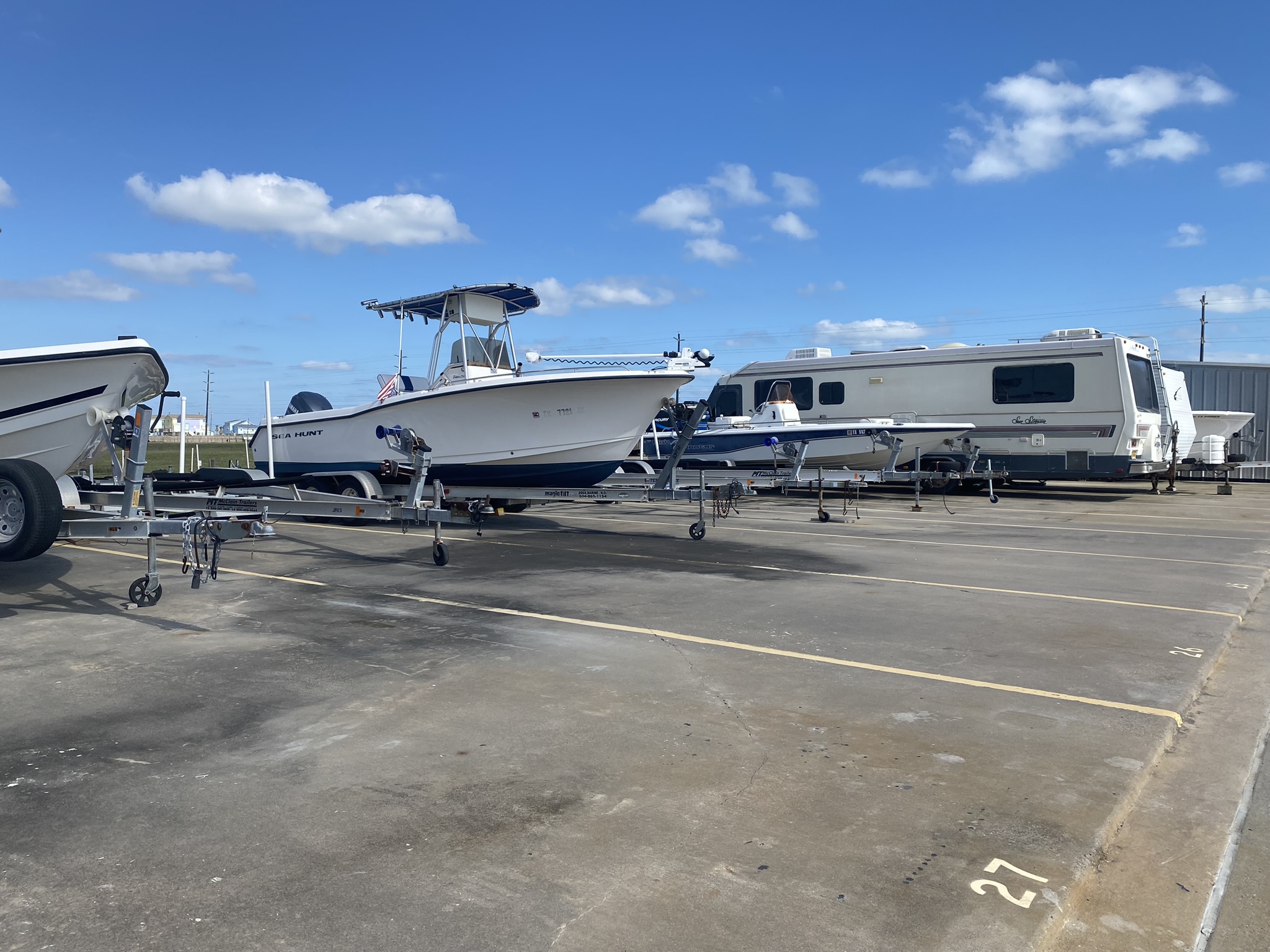 Outdoor boat and RV storage facility in Galveston, TX with secure, paved parking spaces near the coast